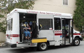 “Passenger boarding a Littleton Area Senior Center shuttle bus using a wheelchair lift.”