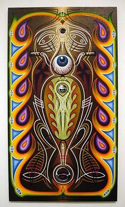 A colorful painting of a peacock with a third eye hanging on a wall.