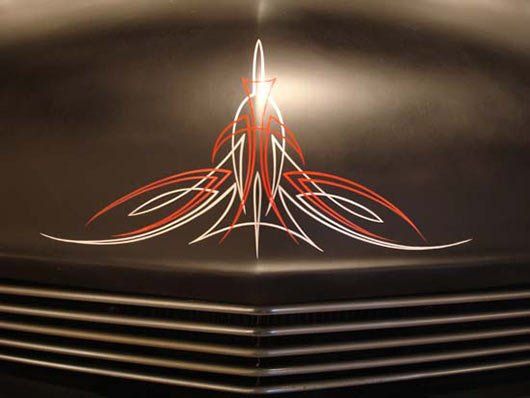 A black car with a red and white pinstripe on the hood