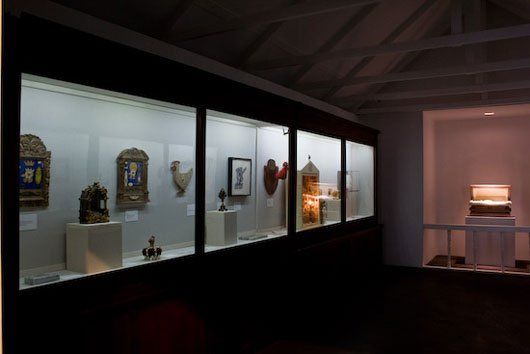 A row of glass display cases filled with various objects