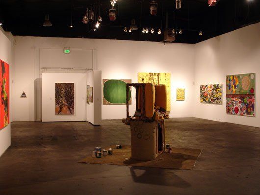A large room with a lot of paintings on the walls