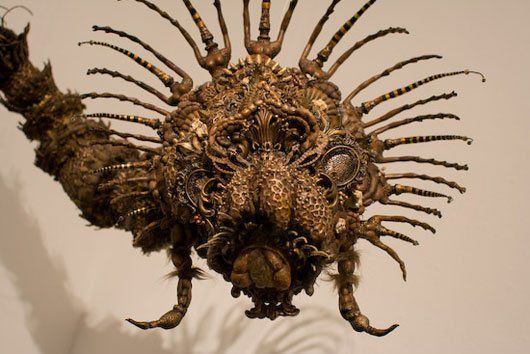 A close up of a sculpture of a spider on a wall