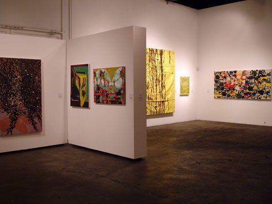 A room with a lot of paintings on the wall