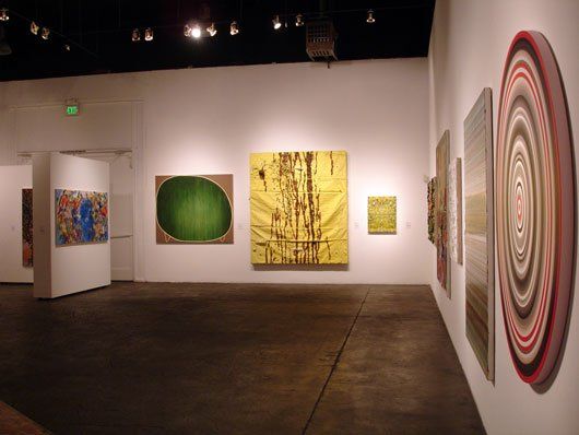 A room with a lot of paintings on the wall