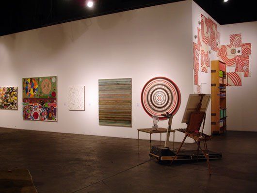 A room with a lot of paintings on the wall