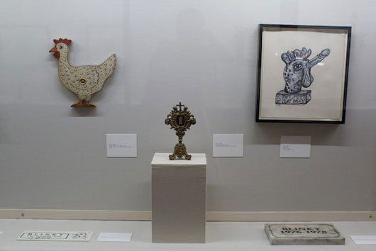 A chicken and a rabbit are on display in a museum.