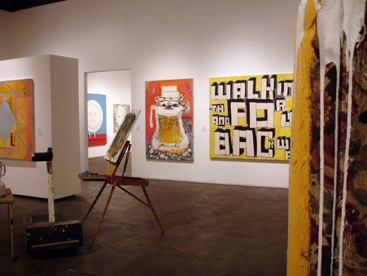 A room with paintings and a sign that says walk