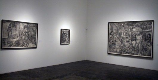 Three paintings are hanging on a wall in a museum.