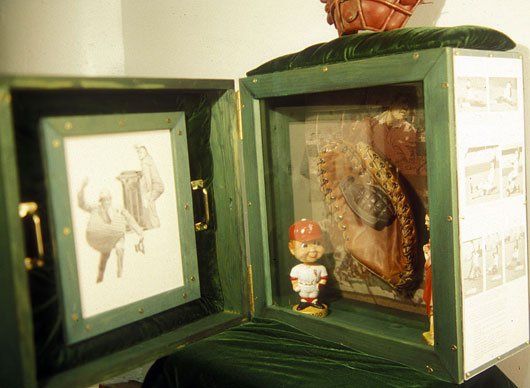 A green box with a picture of a baseball player inside of it