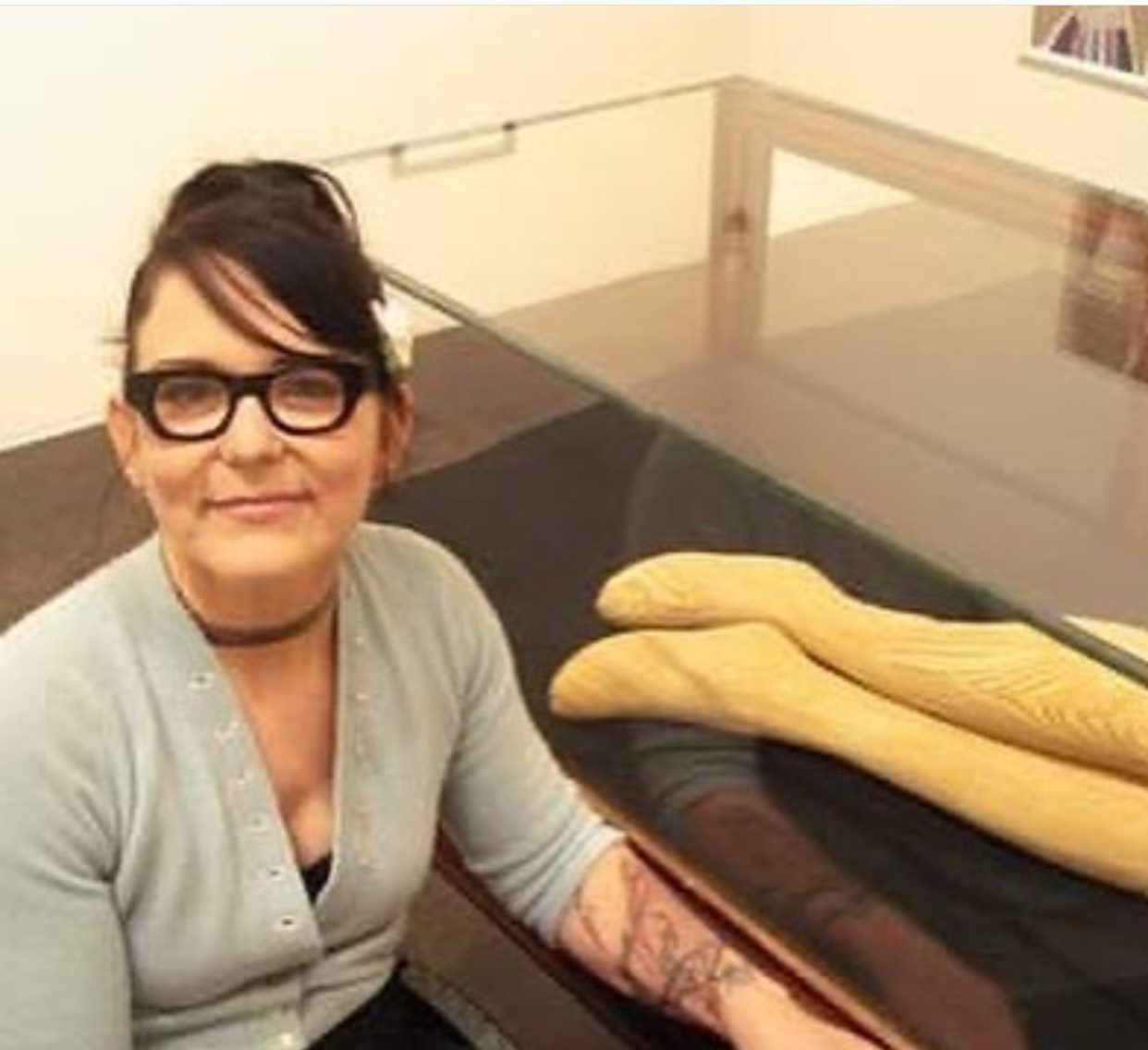 A woman wearing glasses is sitting at a table