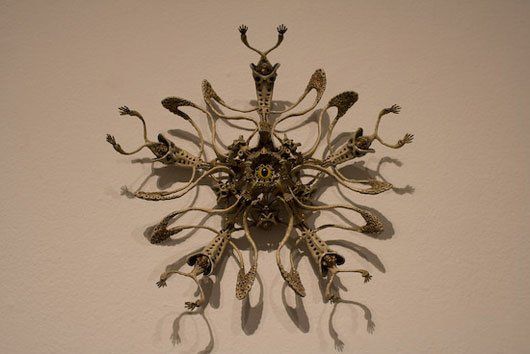 A sculpture on a wall that looks like a snowflake