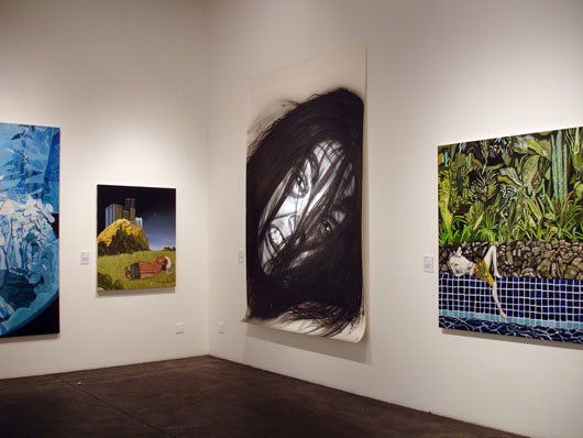 A room with a lot of paintings on the wall