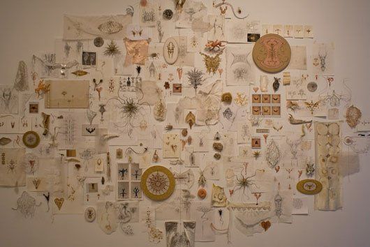 A wall with a lot of drawings on it