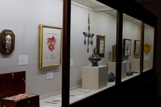 A display case filled with various objects including a picture of a heart