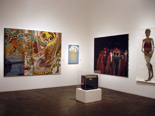 A room with a lot of paintings on the wall