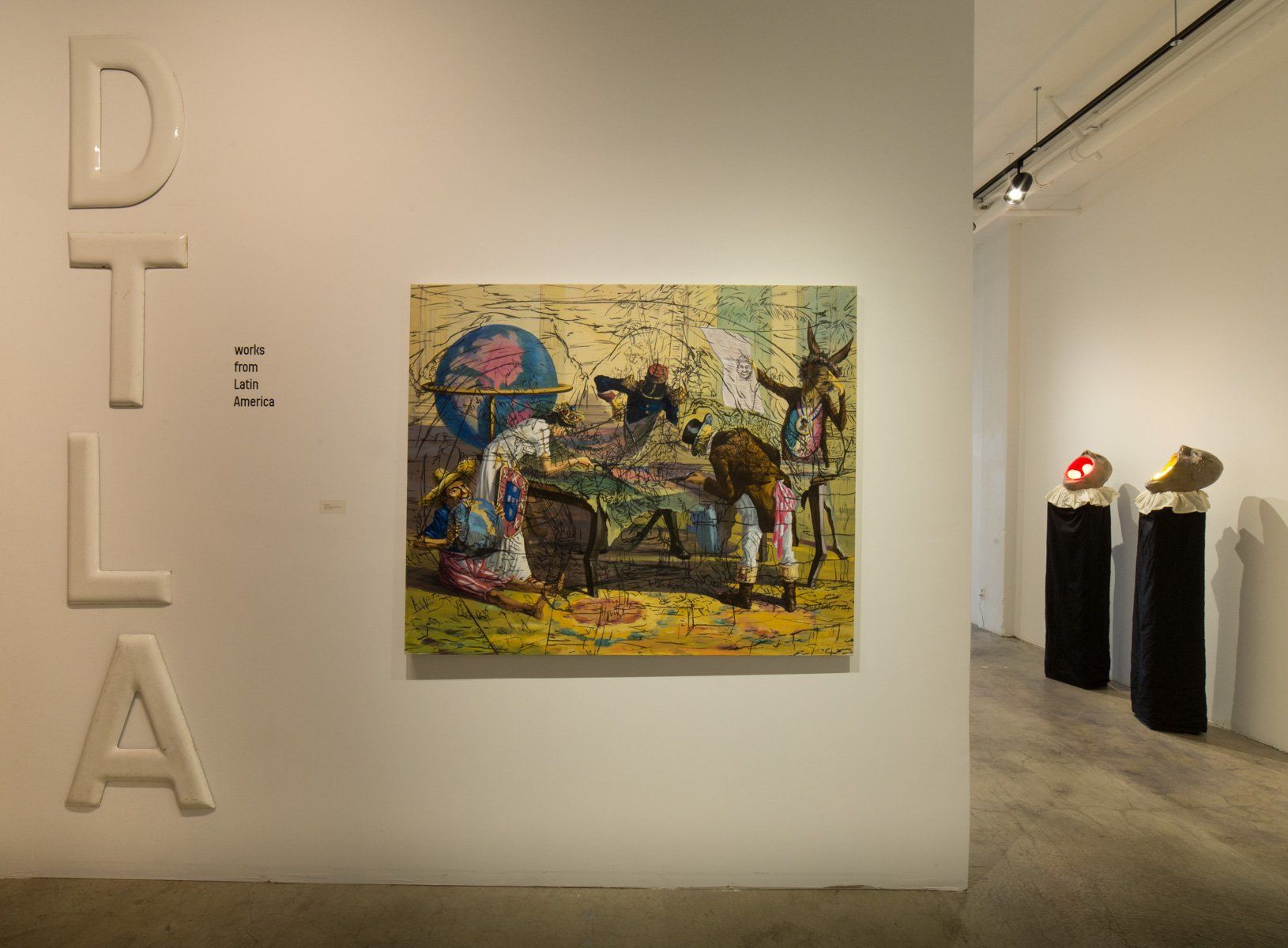 A painting is hanging on a wall in a museum.