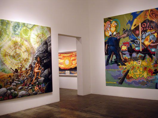A room with a lot of paintings on the wall