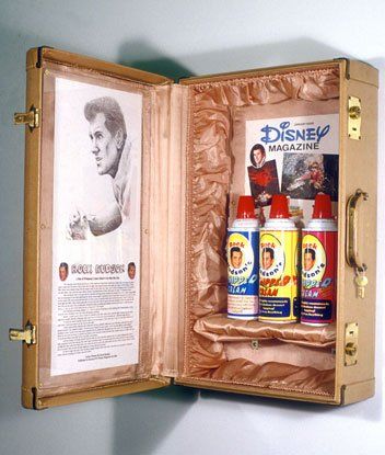 A disney magazine is displayed inside of a suitcase