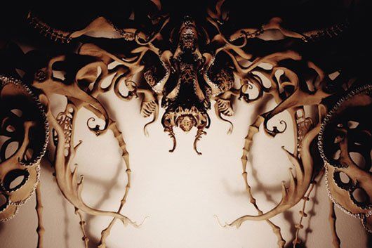 A close up of a sculpture of an octopus on a wall.