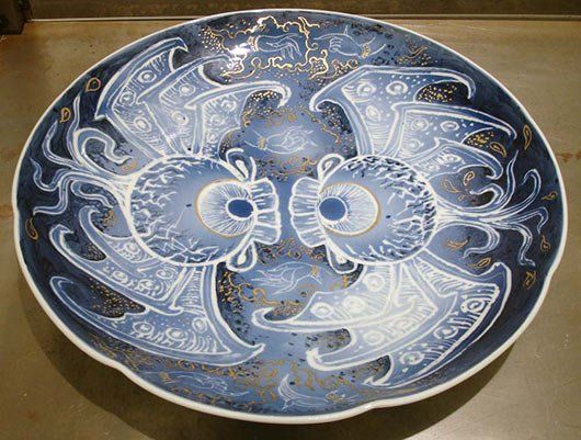 A blue and white plate with a crab design on it is sitting on a table.