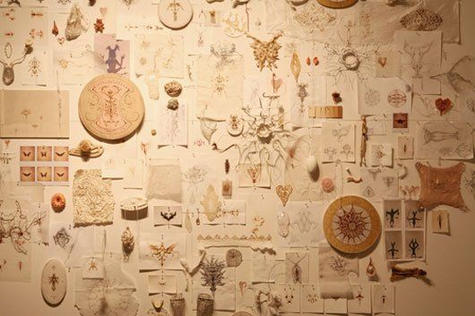 A wall with a lot of drawings on it