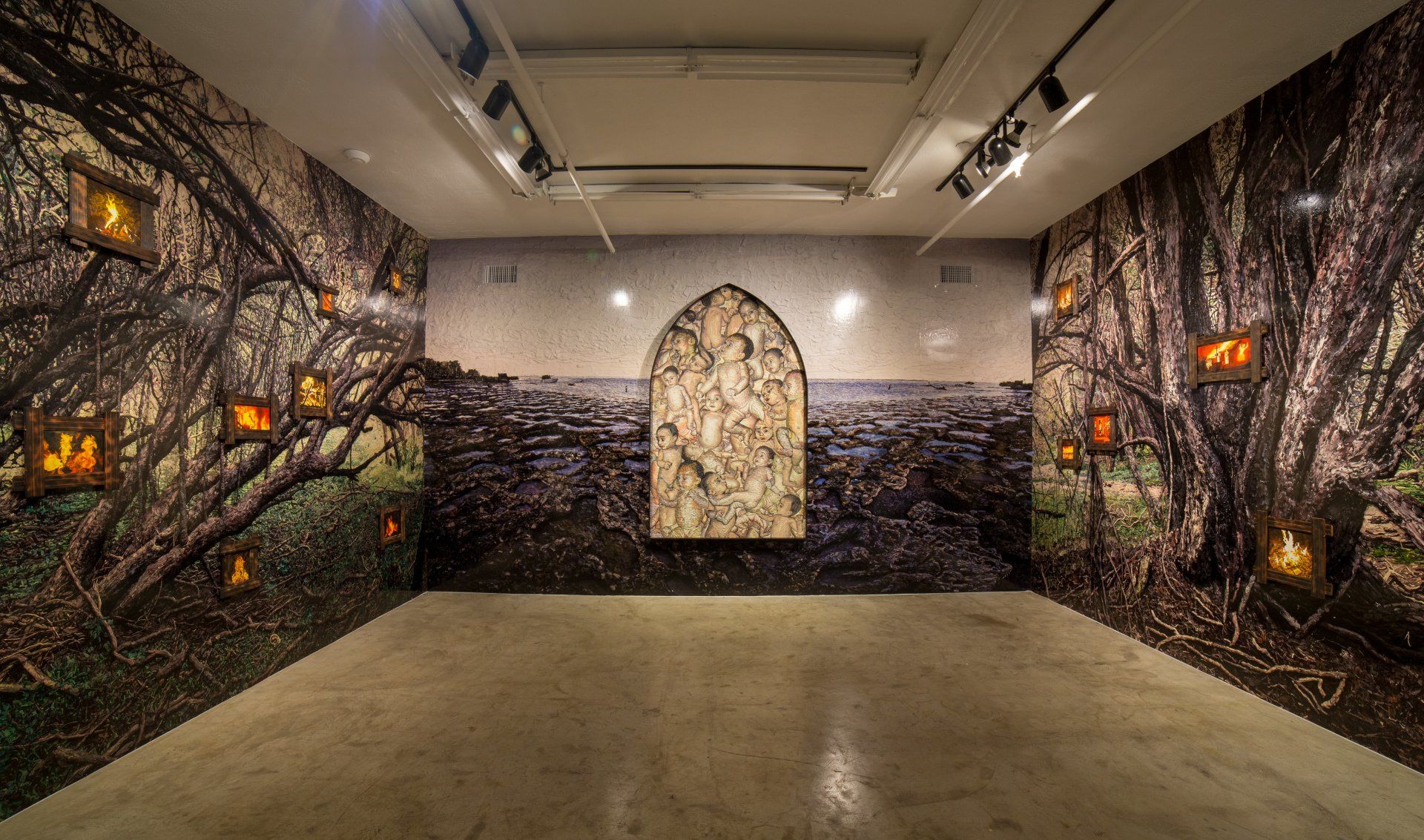 A large empty room with a painting on the wall.