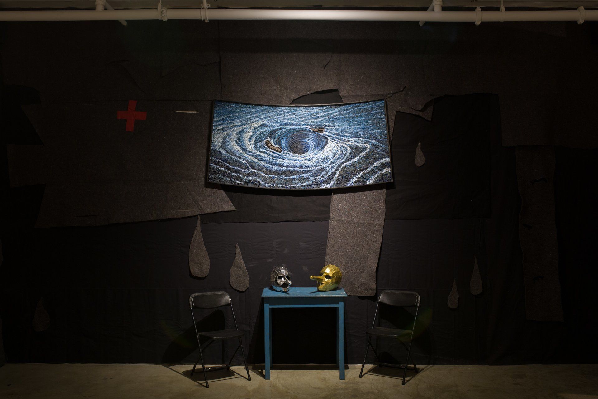 A room with a table and chairs and a painting on the wall.