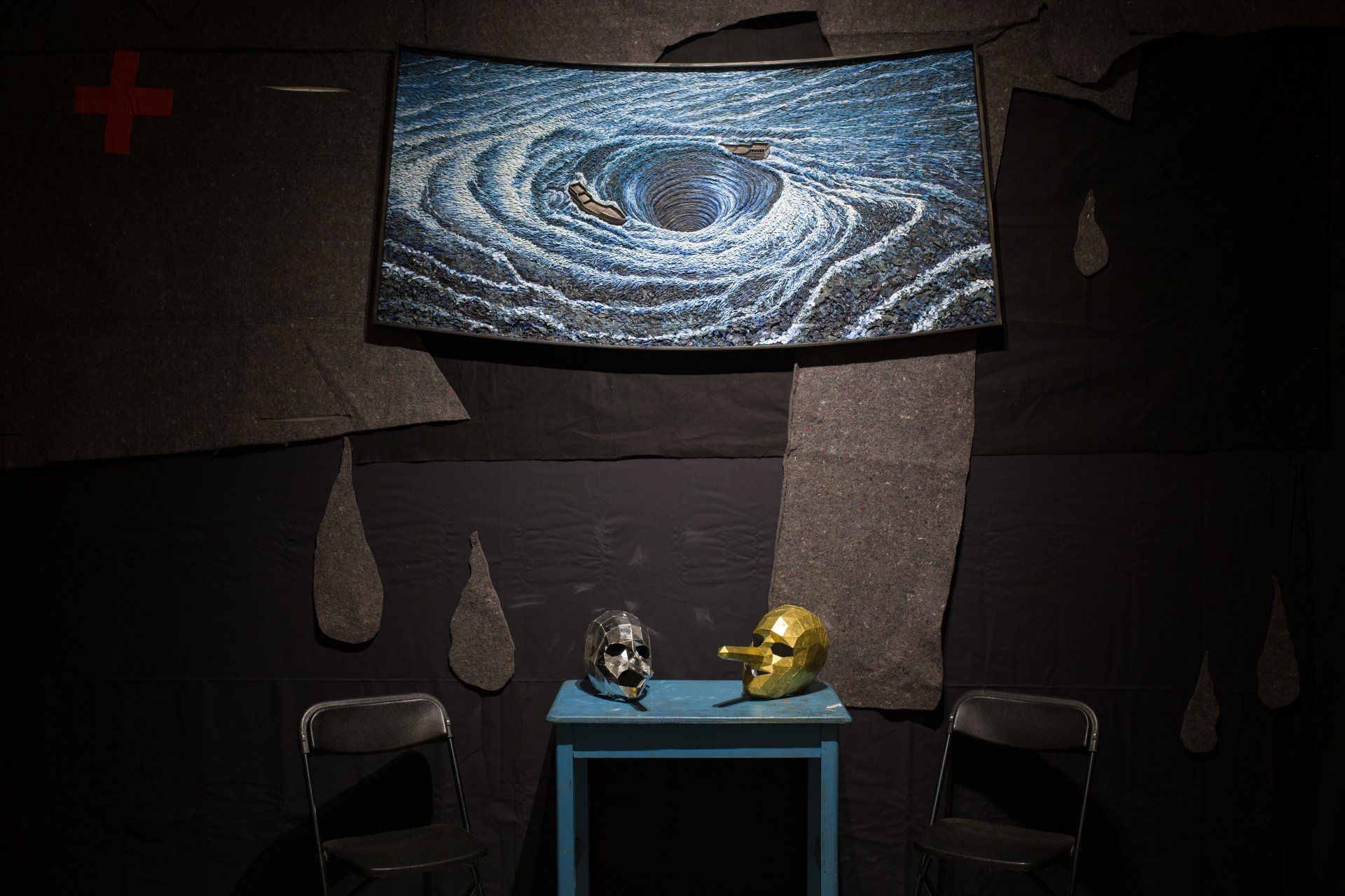 A room with a table and chairs and a painting on the wall.