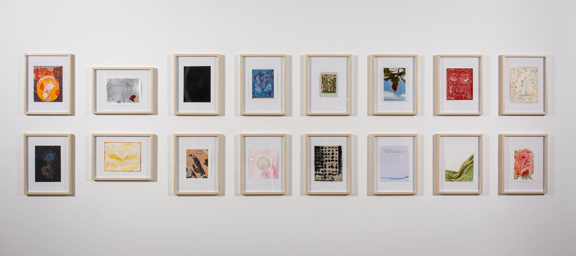A group of paintings are hanging on a wall.