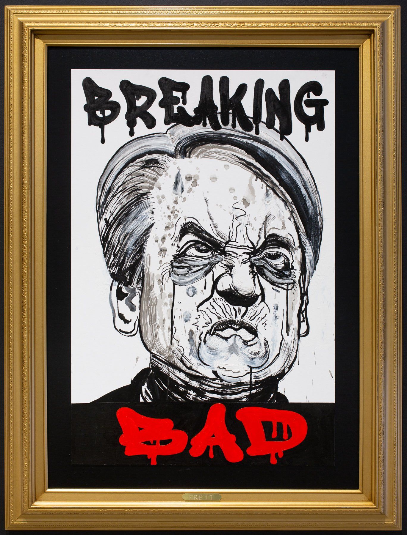 A framed picture of a man with the words breaking bad on it