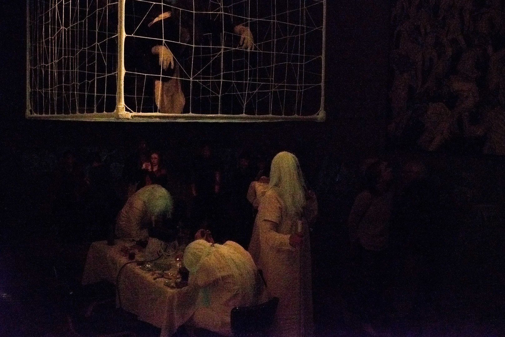 A group of people standing around a table in a dark room