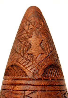 A close up of a wooden object with a star on it.