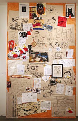 A bulletin board with a lot of pictures and drawings on it.