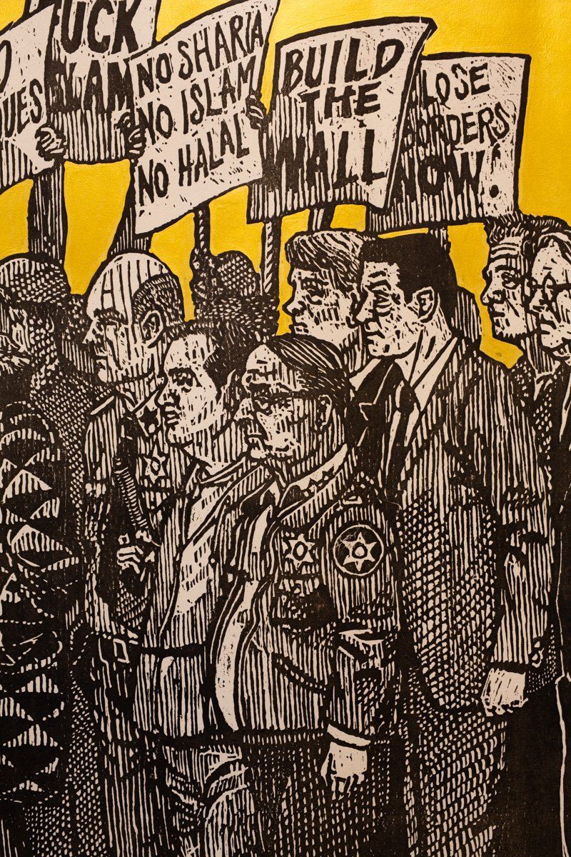 A drawing of a group of people holding signs that say build the wall