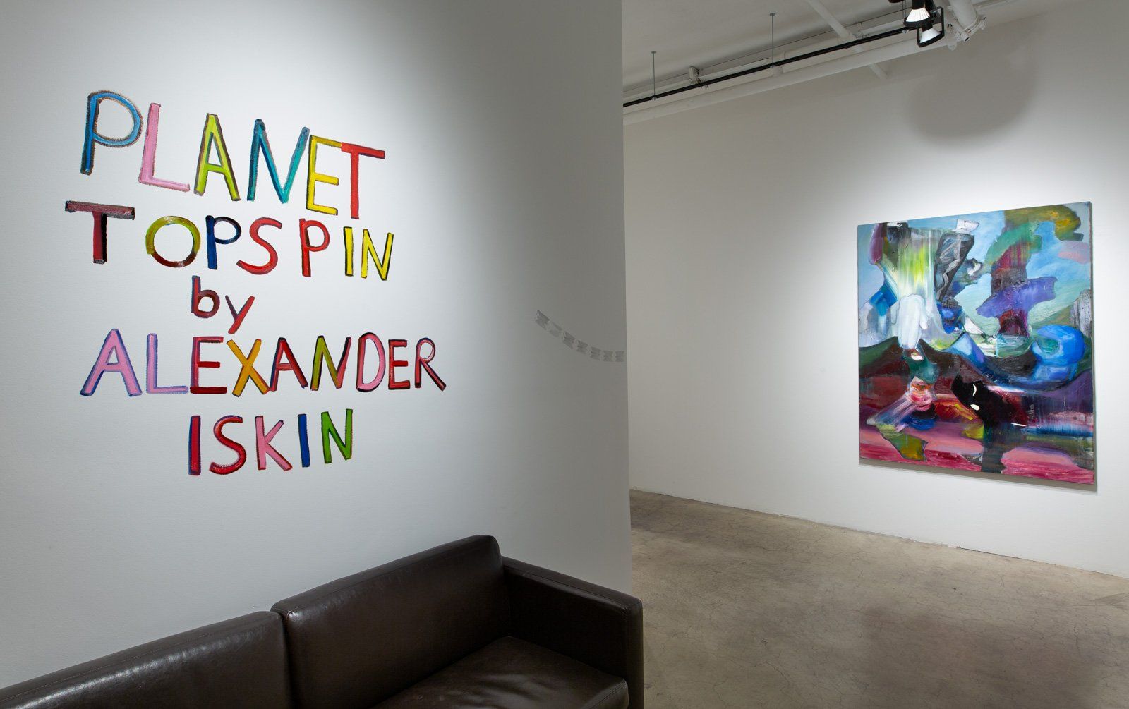 A room with a couch and a painting on the wall that says planet tops pin by alexander iskin