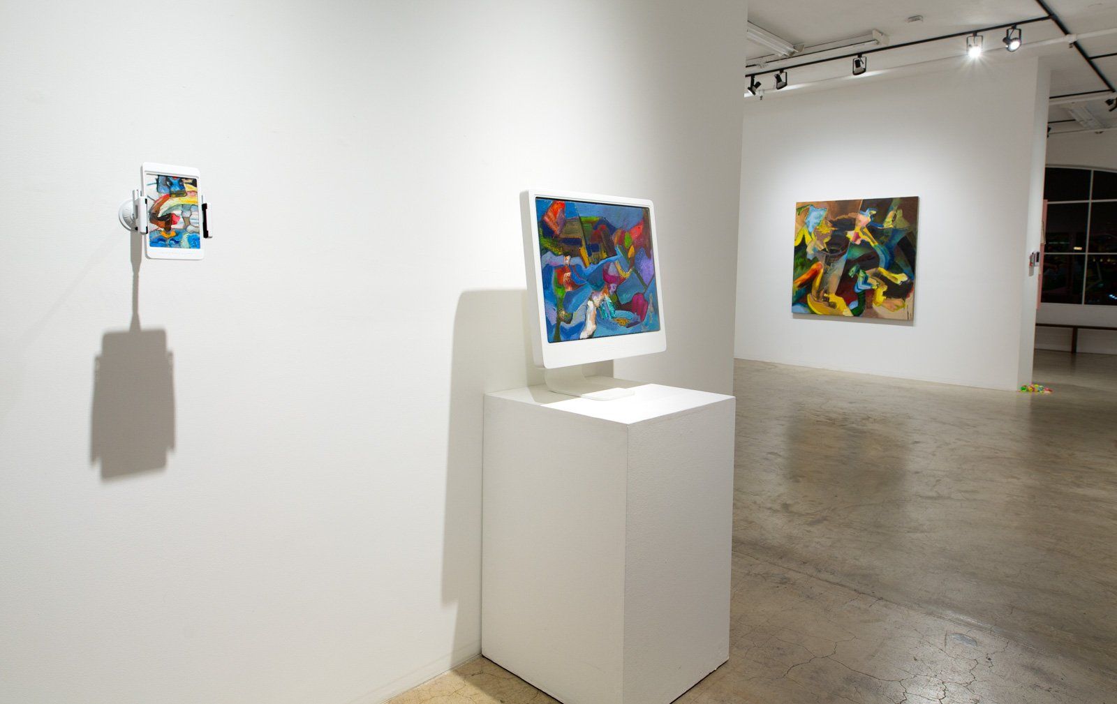 There are two paintings on the wall in the room.