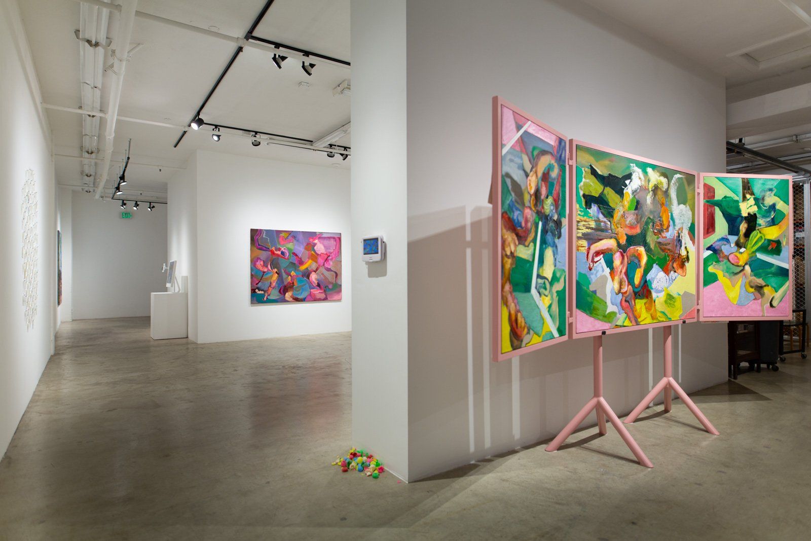 There are three paintings on display in a museum.