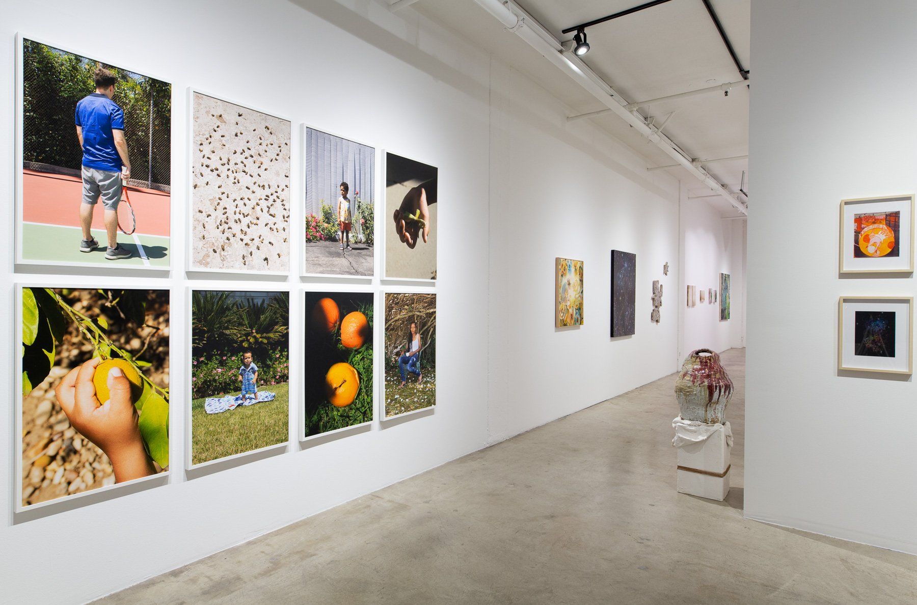 A gallery with a lot of pictures on the wall.