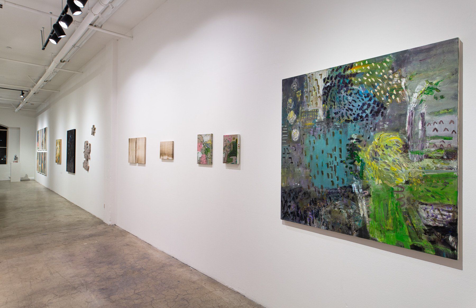 A painting is hanging on a wall in a gallery.