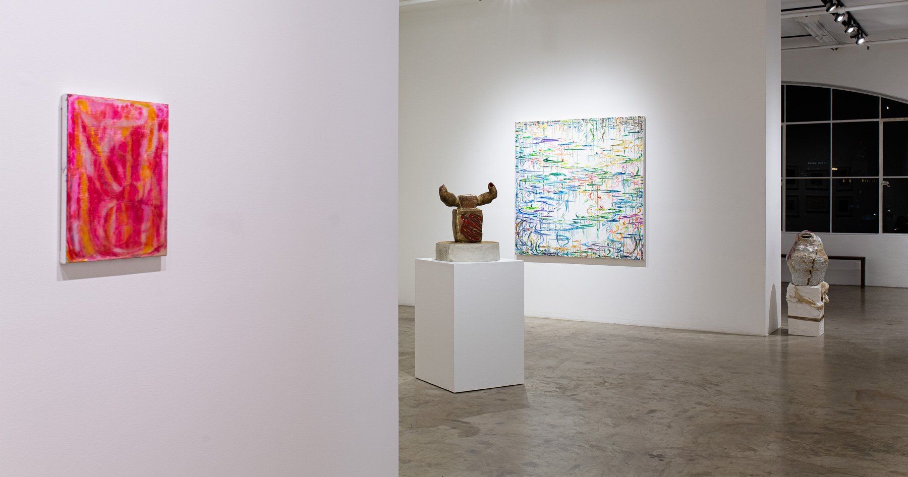 There are a lot of paintings and sculptures in this room.