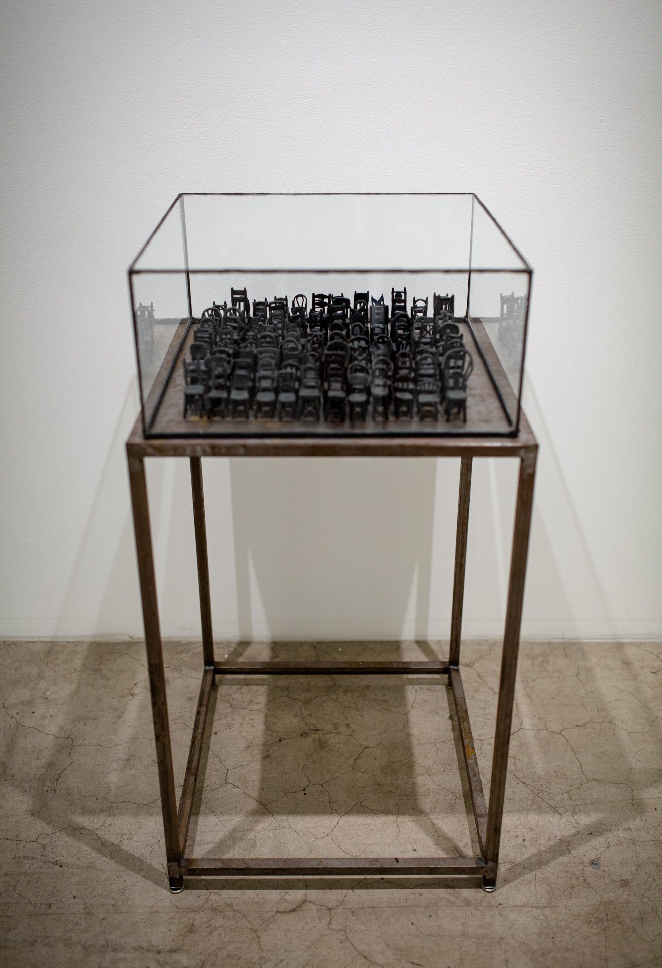 A glass display case with a chess board inside of it