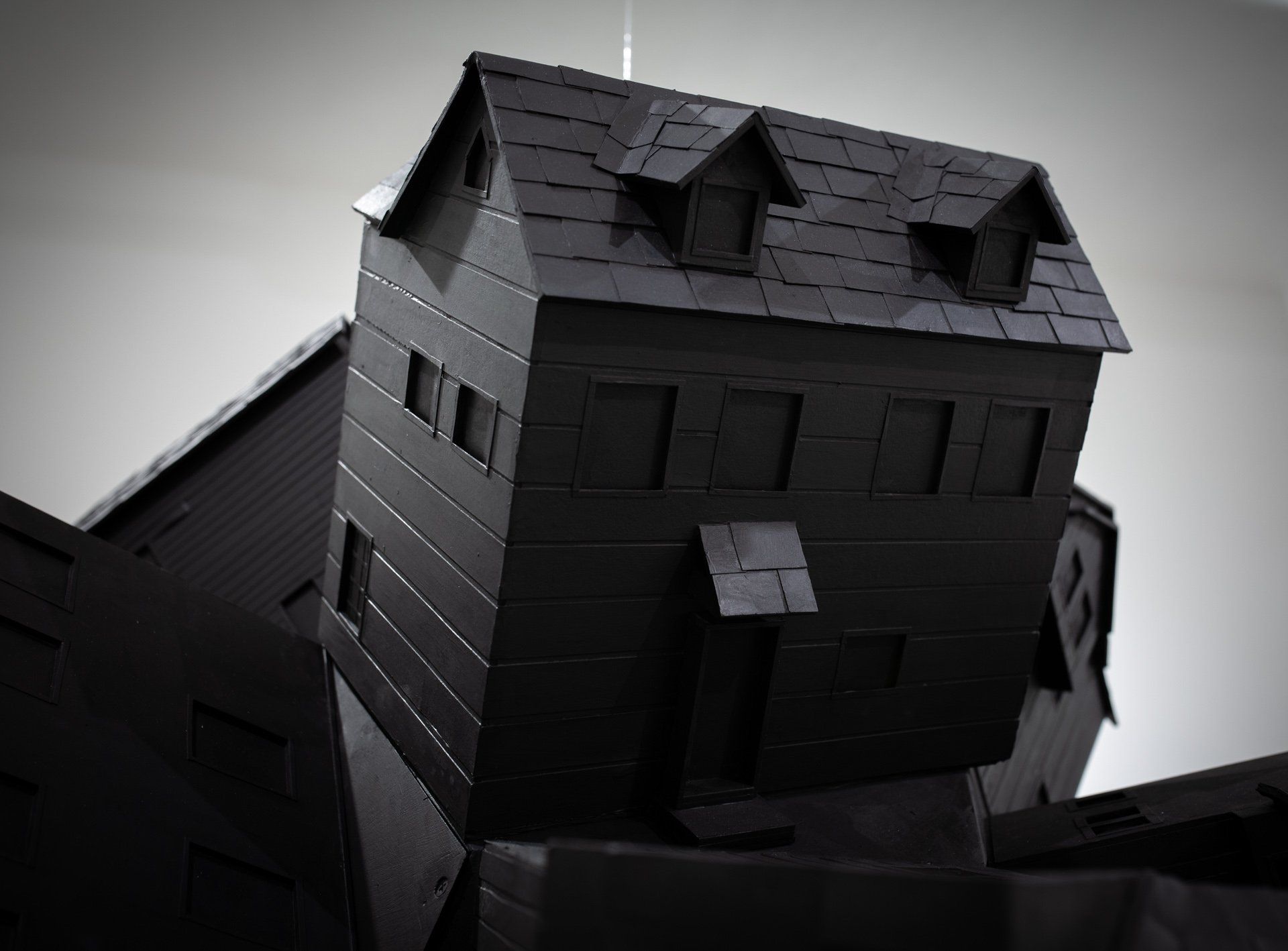 A black house is sitting on top of a black building