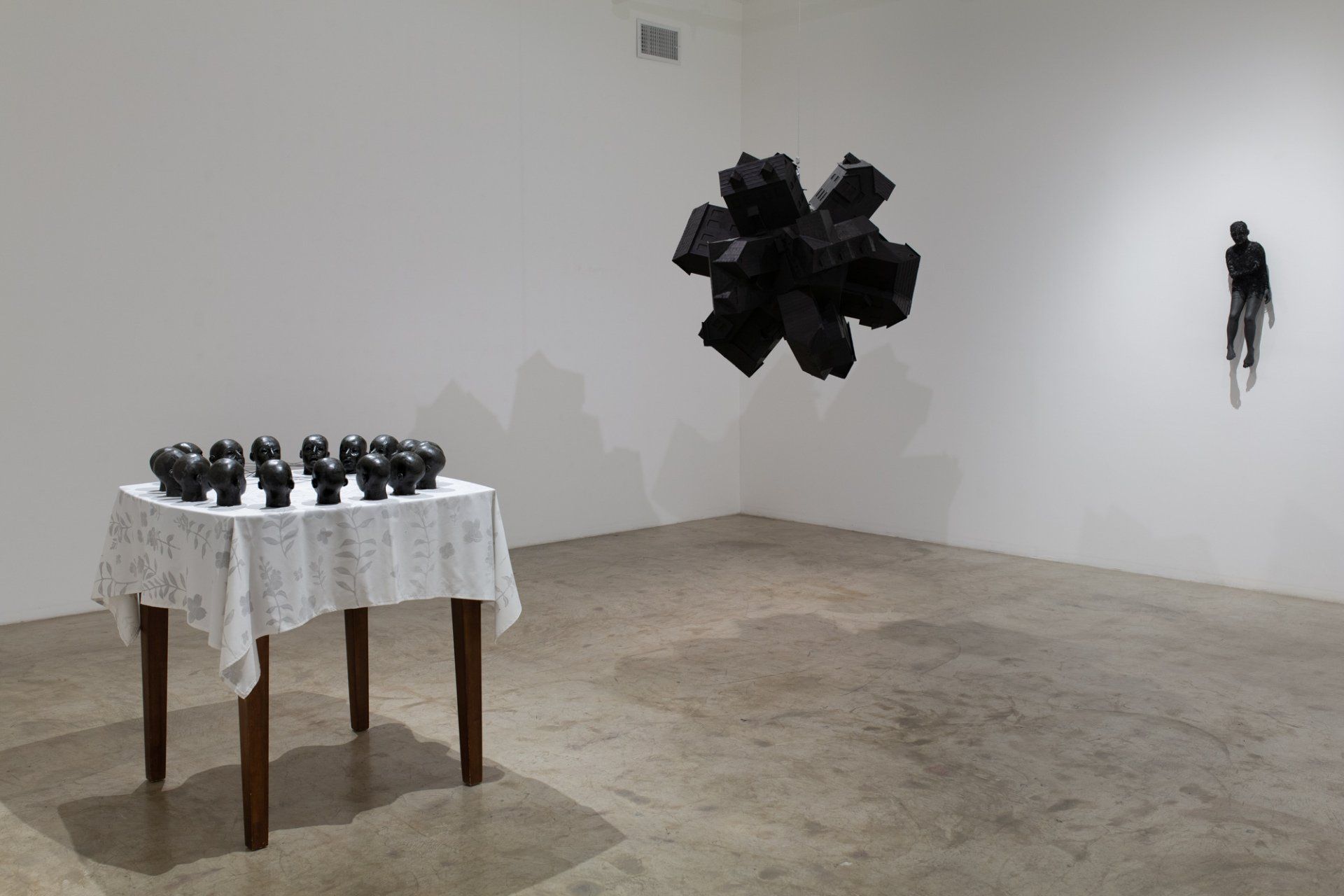 A room with a table and a sculpture on the wall