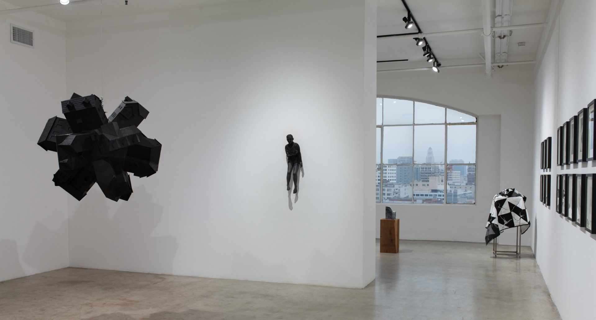A large white room with a lot of artwork on the walls