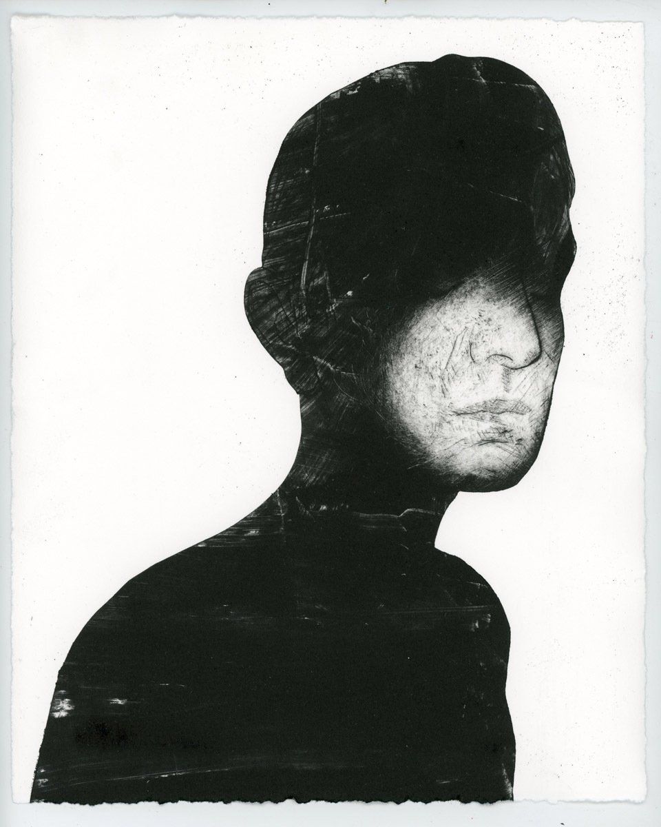 A black and white photo of a woman 's face
