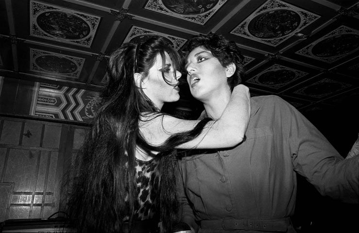 Two women are hugging each other in a black and white photo.