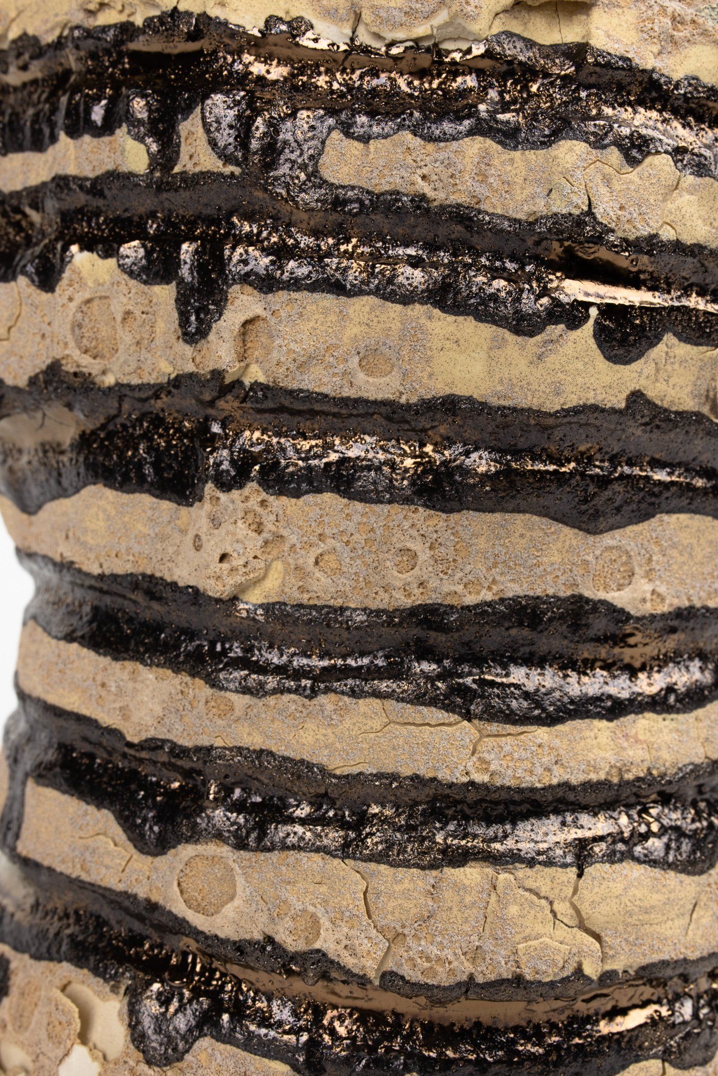 A close up of a piece of wood with black stripes on it.