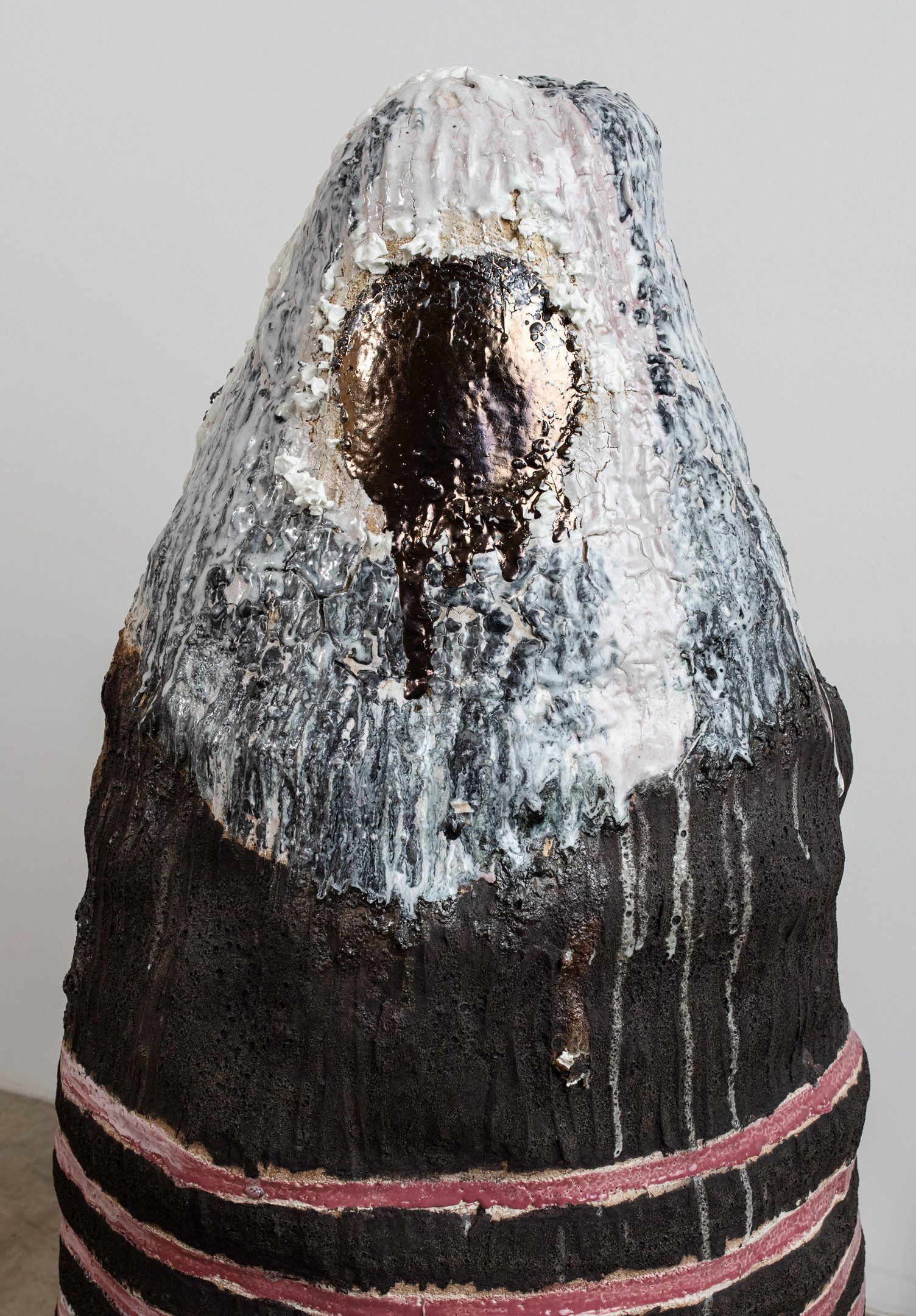 A close up of a statue of a bird with a striped skirt