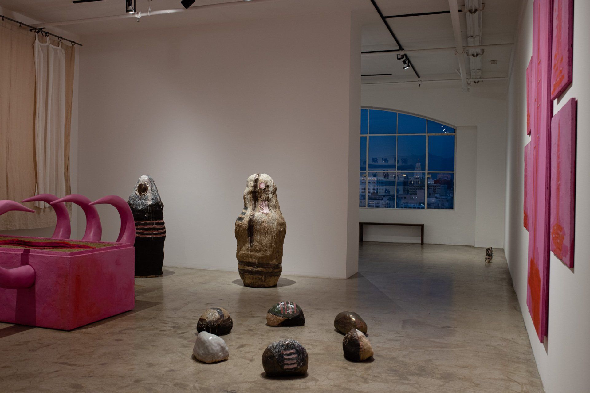 A room with a lot of sculptures on the floor and walls.