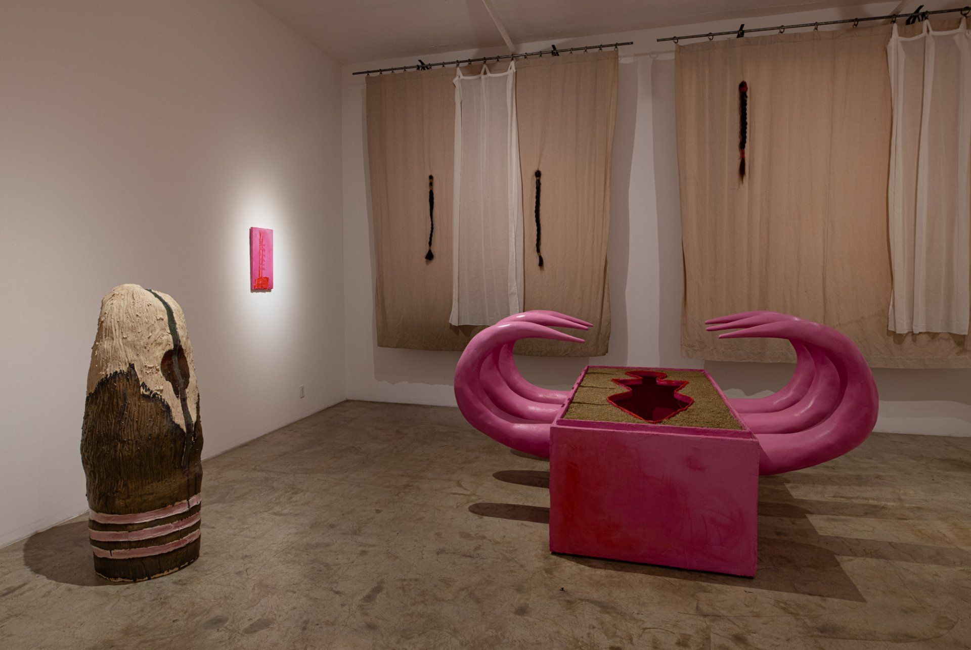 A room with a pink sculpture in the middle of it.